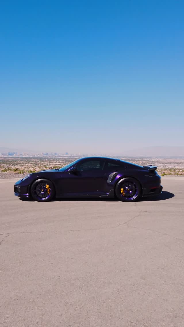 Purple Porsche 911 Turbo S with widebody aero above the Las Vegas valley