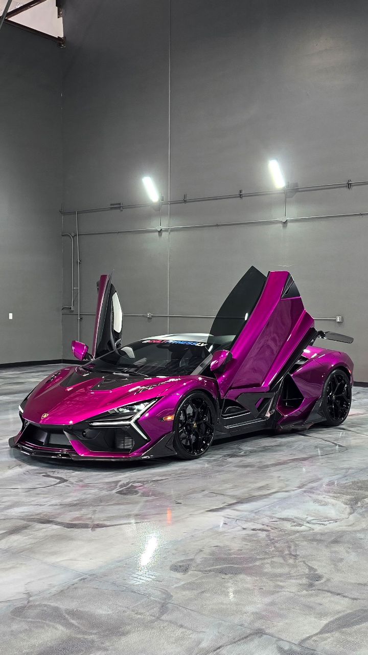 Lamborghini Revuelto in a custom purple chrome finish with doors up inside the Lusso shop