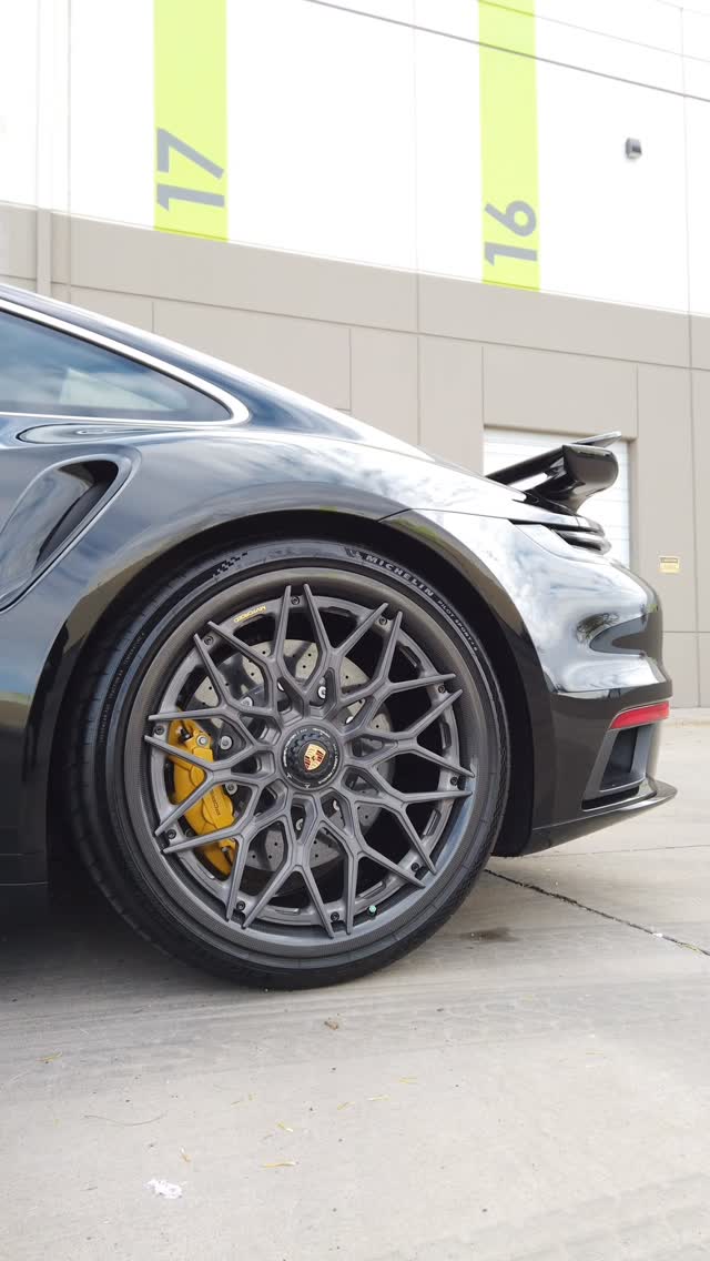 Black Porsche 911 Turbo on grey mesh forged wheels with yellow calipers
