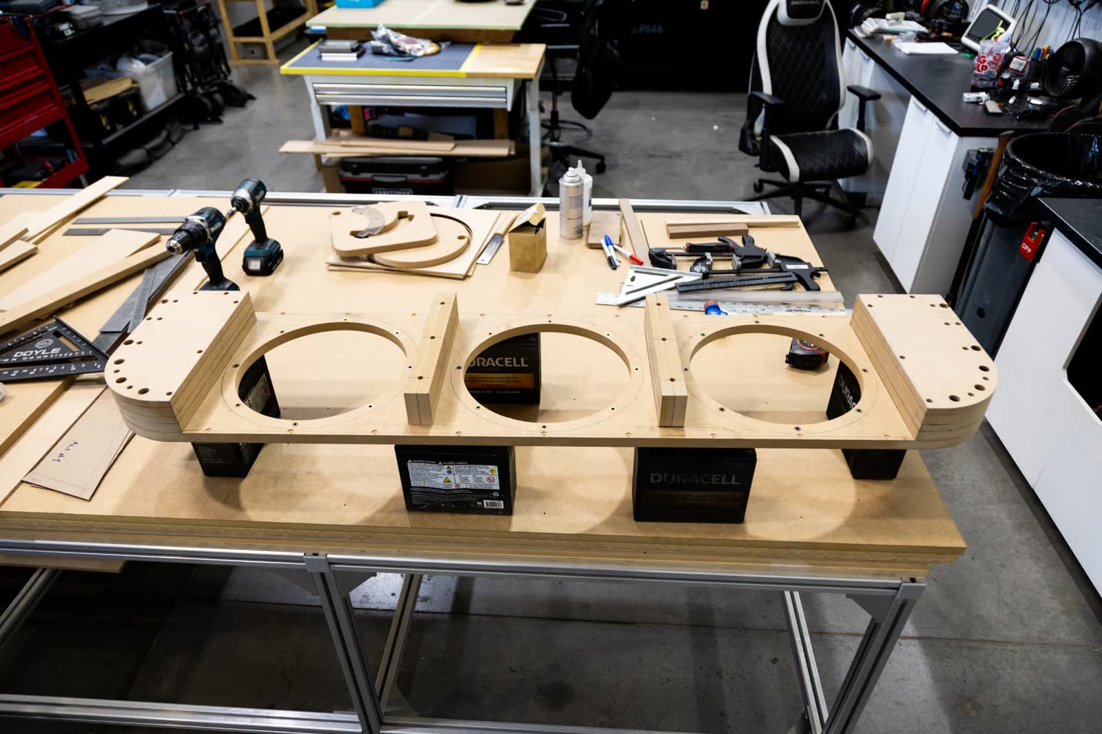 Triple subwoofer baffle mocked up during custom enclosure fabrication at Lusso