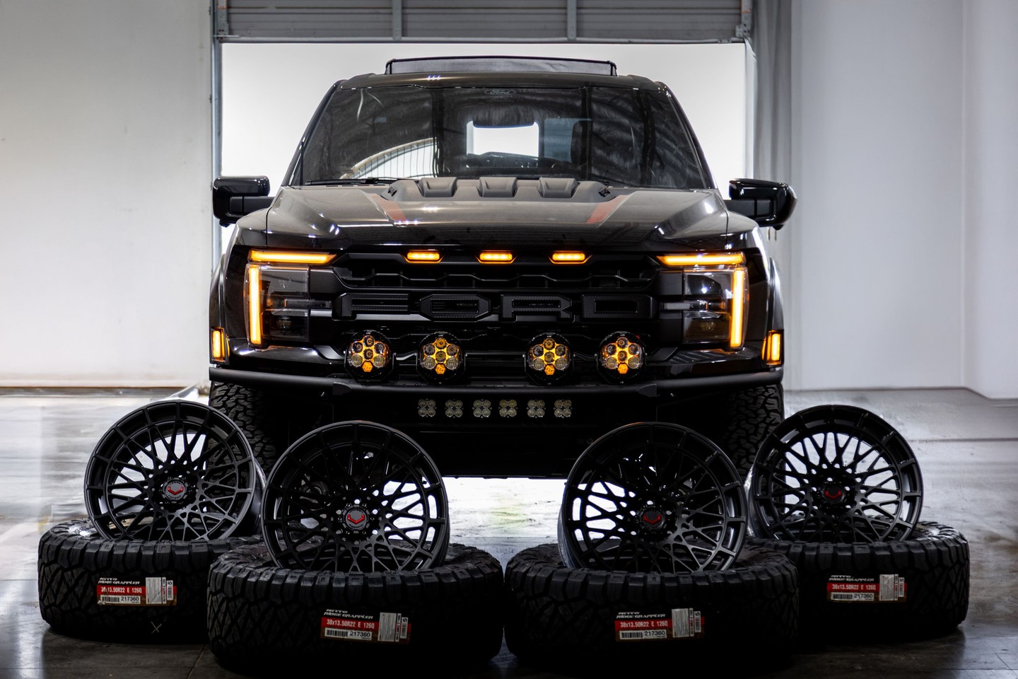 Ford Raptor with a set of gloss black forged wheels and off road tires