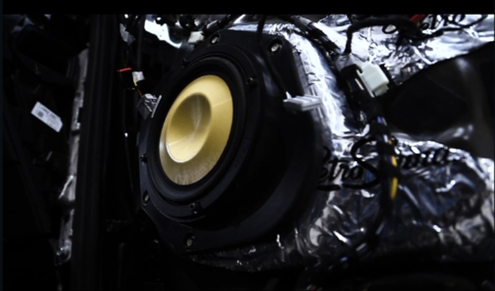 Focal subwoofer install with sound deadening visible behind it